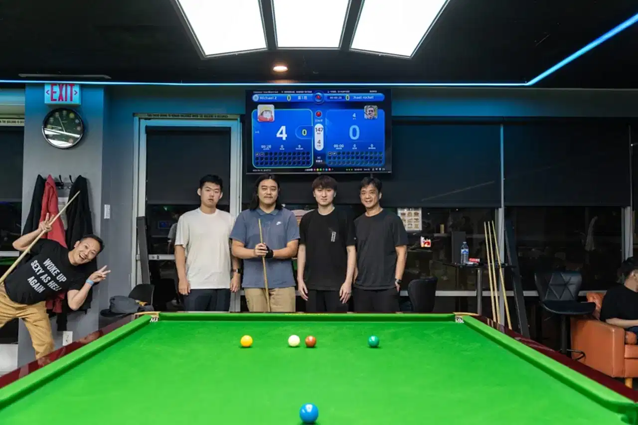 iCUE Billiard Club snooker tournament players with AI smart table scoring screen